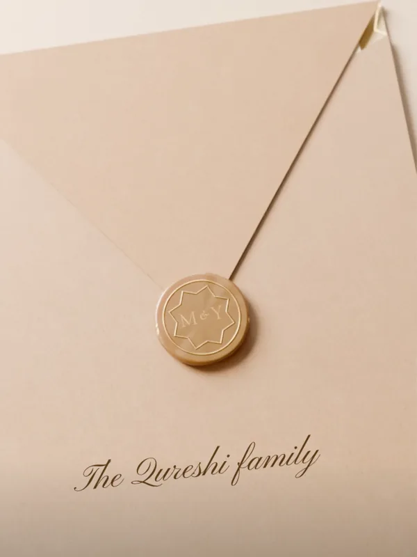 An ivory envelope sealed in gold wax, “The Qureshi family” written below the seal